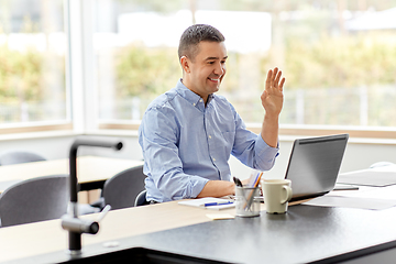 Image showing man with laptop having video call at home office