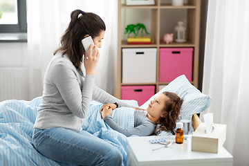 Image showing ill daughter and mother calling on phone at home