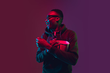 Image showing African-american man\'s portrait isolated on gradient studio background in neon light