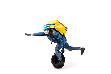 Image showing Too much orders. Contacless delivery service during quarantine. Man delivers food and shopping bags during isolation, wearing gloves and face mask.