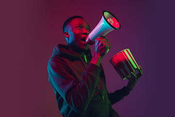 Image showing African-american man\'s portrait isolated on gradient studio background in neon light