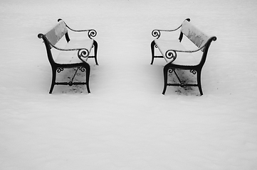 Image showing Two benches in the snow.