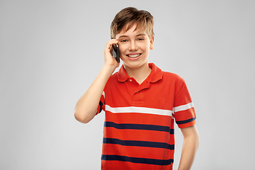 Image showing happy smiling boy calling on smartphone