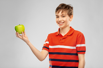 Image showing portrait of happy smiling boy holding green apple