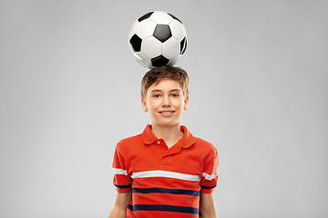 Image showing happy smiling boy with soccer ball on his head