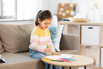 Image showing little girl drawing with coloring pencils at home