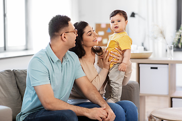 Image showing portrait of happy family sitting on sofa at home