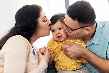 Image showing happy mother and father kissing baby son at home