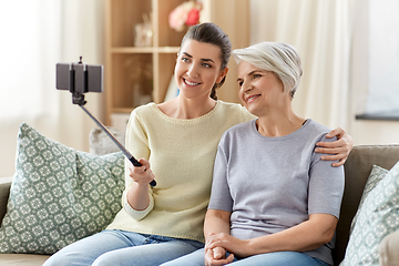 Image showing senior mother with daughter taking selfie at home