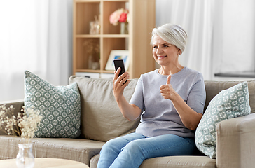 Image showing senior woman having video call on smartphone