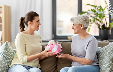 Image showing adult daughter giving present to her senior mother