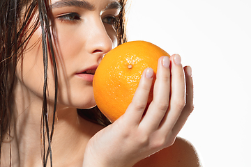 Image showing Close up of beautiful female face with organic treatment over white background. Cosmetics and makeup, natural and eco treatment, skin care.