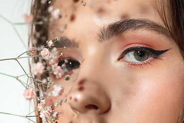 Image showing Close up of beautiful female face with organic treatment over white background. Cosmetics and makeup, natural and eco treatment, skin care.