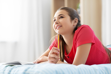 Image showing teenage girl writing to diary at home