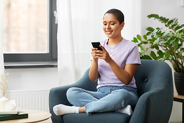 Image showing african american woman with smartphone at home