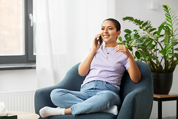 Image showing african woman calling on smartphone at home