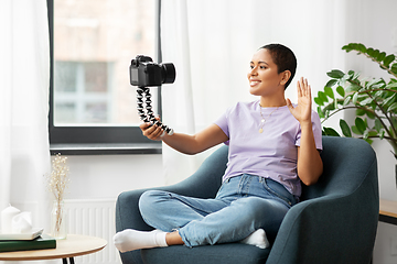 Image showing female blogger with camera video blogging at home