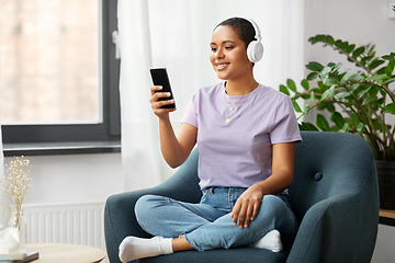 Image showing woman with smartphone listening to music at home