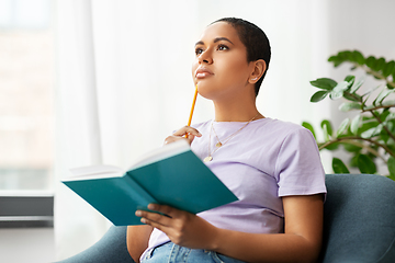 Image showing african american woman with diary at home