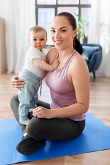 Image showing happy mother with little baby at home