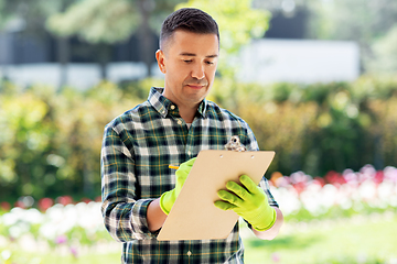 Image showing man with clipboard at summer garden