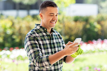 Image showing happy man with smartphone at summer garden