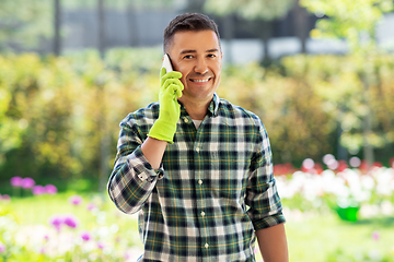 Image showing happy man calling on smartphone at summer garden