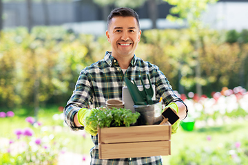 Image showing happy man with tools in box at summer garden