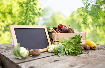 Image showing close up of vegetables with chalkboard on farm