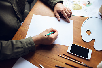 Image showing Close up of man drawing with paints and pencils at home. Remote education, creative occupation, art therapy