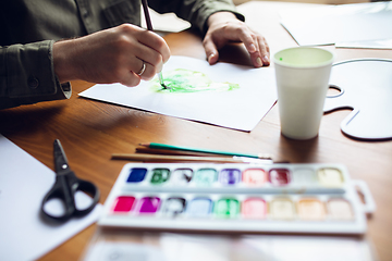 Image showing Close up of man drawing with paints and pencils at home. Remote education, creative occupation, art therapy