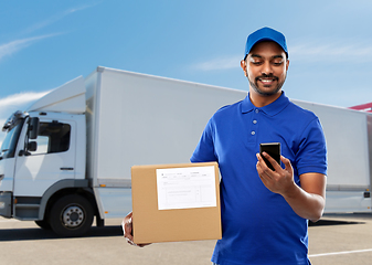 Image showing indian delivery man with smartphone and parcel box