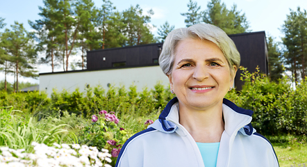 Image showing smiling sporty senior woman at summer park