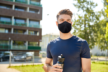 Image showing young sporty man with bottle outdoors