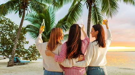 Image showing young women toasting non alcoholic drinks on beach