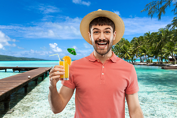 Image showing happy man in straw hat with orange juice cocktail