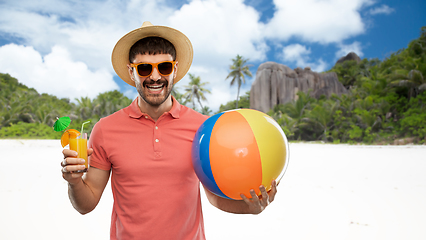 Image showing happy man with orange juice and beach ball