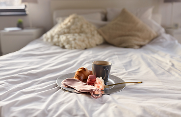 Image showing croissant, coffee and eye sleeping mask in bed