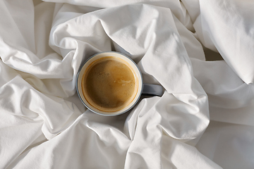 Image showing cup of coffee in bed