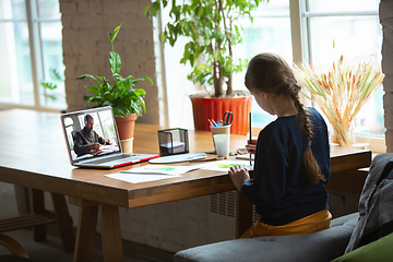 Image showing Girl drawing with paints and pencils at home, watching teacher\'s tutorial on laptop. Digitalization, remote education