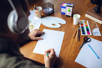 Image showing Close up of man giving online drawing lessons at home. Recording teacher\'s tutorial on camera for kids. Digitalization, remote education