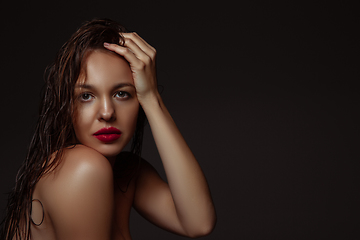 Image showing Portrait of beautiful stylish woman isolated on dark studio background