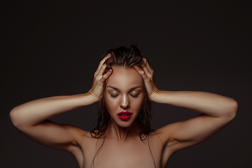 Image showing Portrait of beautiful stylish woman isolated on dark studio background