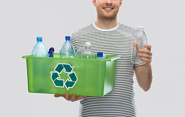 Image showing smiling young man sorting plastic waste
