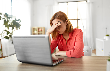 Image showing stressed woman with laptop working at home office