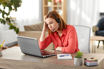 Image showing sad woman with headset and laptop working at home