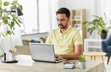 Image showing indian man with laptop working at home office