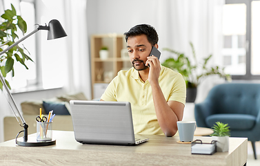 Image showing man calling on smartphone at home office