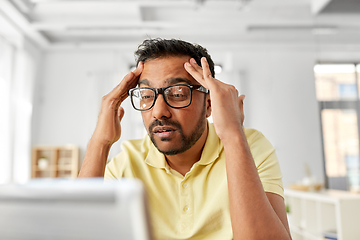 Image showing stressed man with laptop working at home office