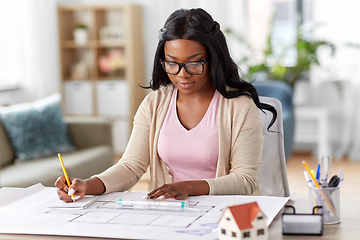 Image showing female architect with house model and blueprint